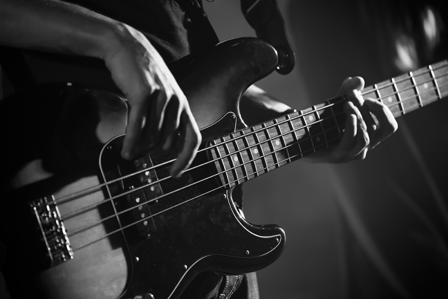 Close up photo of bass guitar player